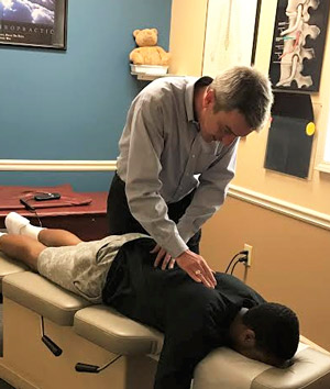 Dr. Gregg giving a chiropractic adjustment. 
