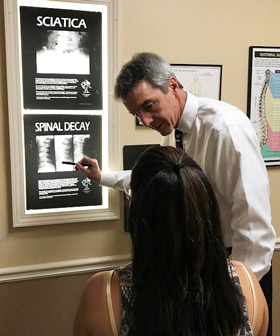 Dr. Gregg explaining chiropractic to patient.