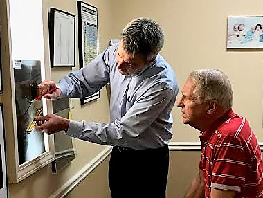 Dr. Gregg explaining x-rays to patient. 